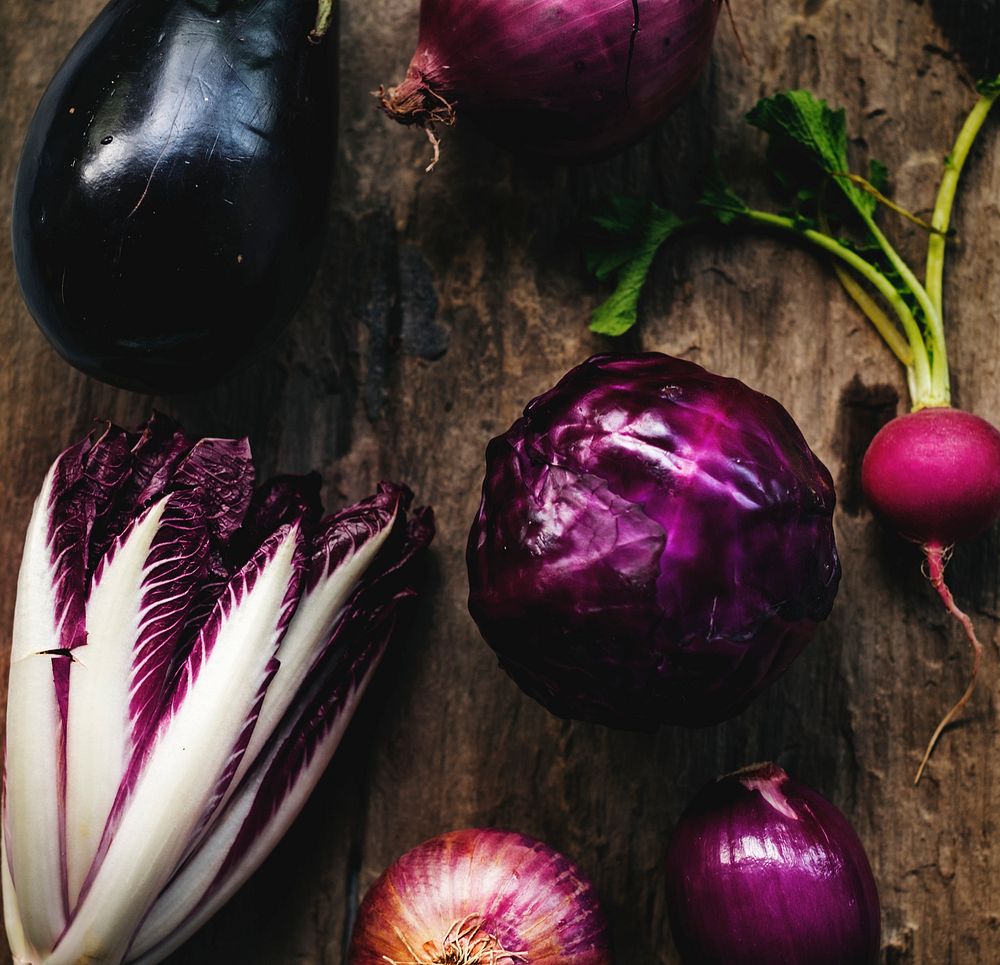 Closeup of purple vegetable group collection on wooden table