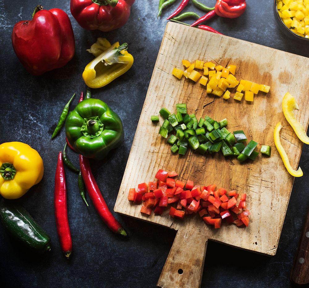 Aerial view of  of various cut bell peppers on wooden cutboard