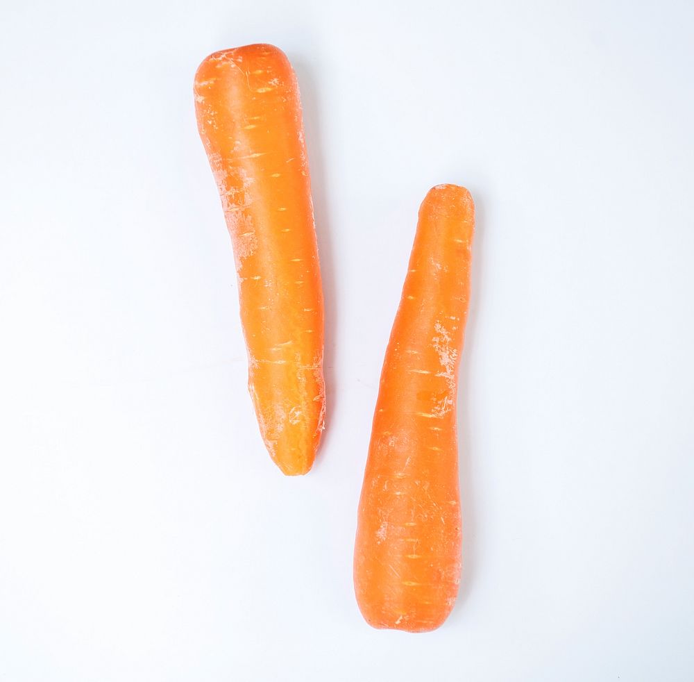 Aerial view of fresh organic carrots with white background