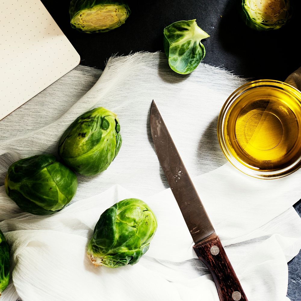 Aerial view of brussle sprouts with knife and cooking oil