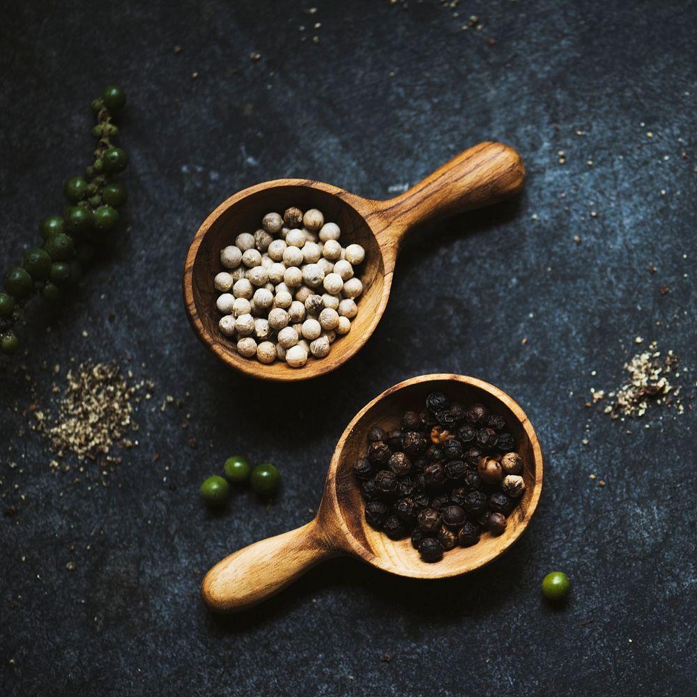 Aerial view of peppercorns on black background