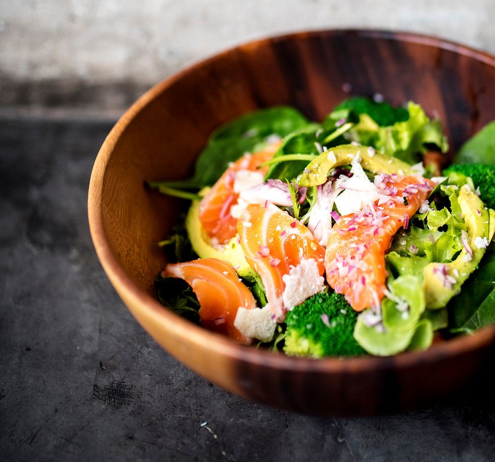 Avocado salmon salad healthy food in rustic style