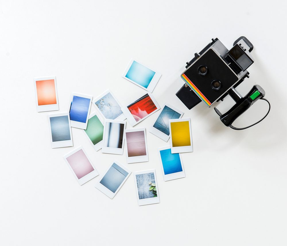Instant camera and photos isolated on background