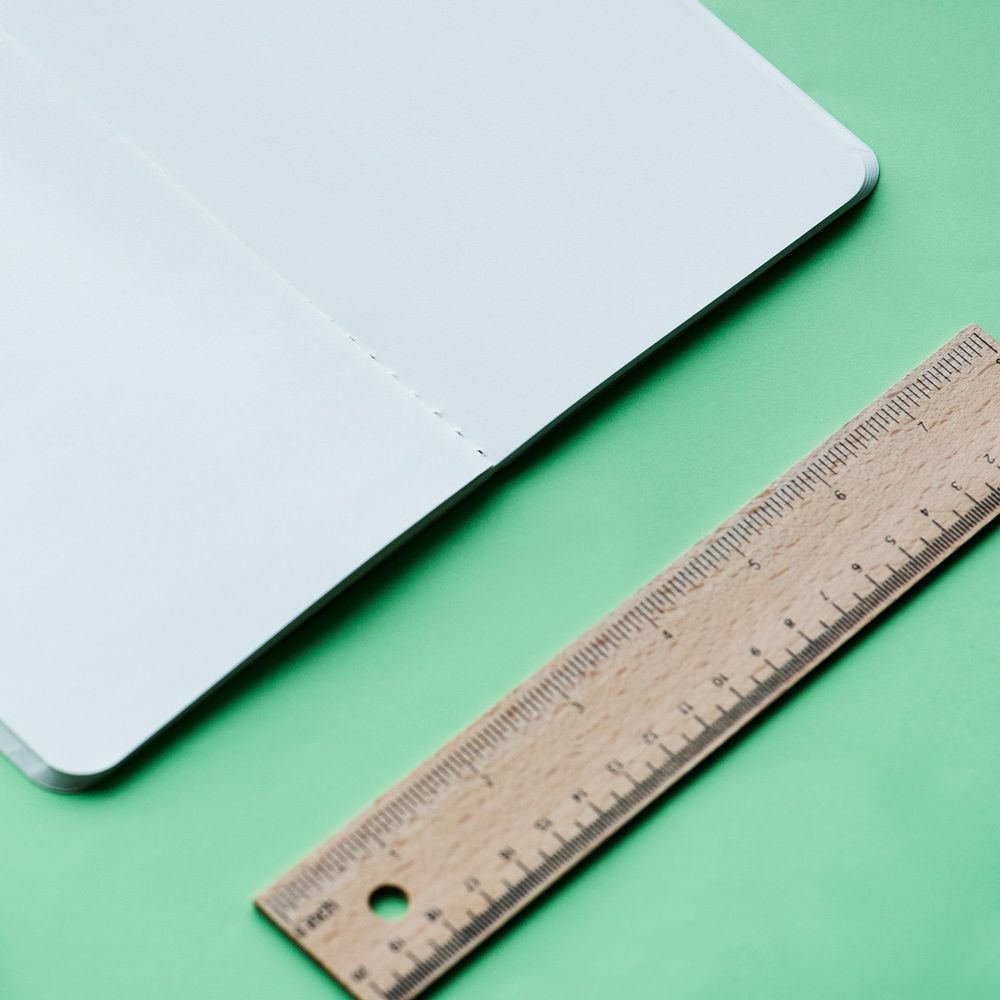 Blank notebook and ruler isolated on background