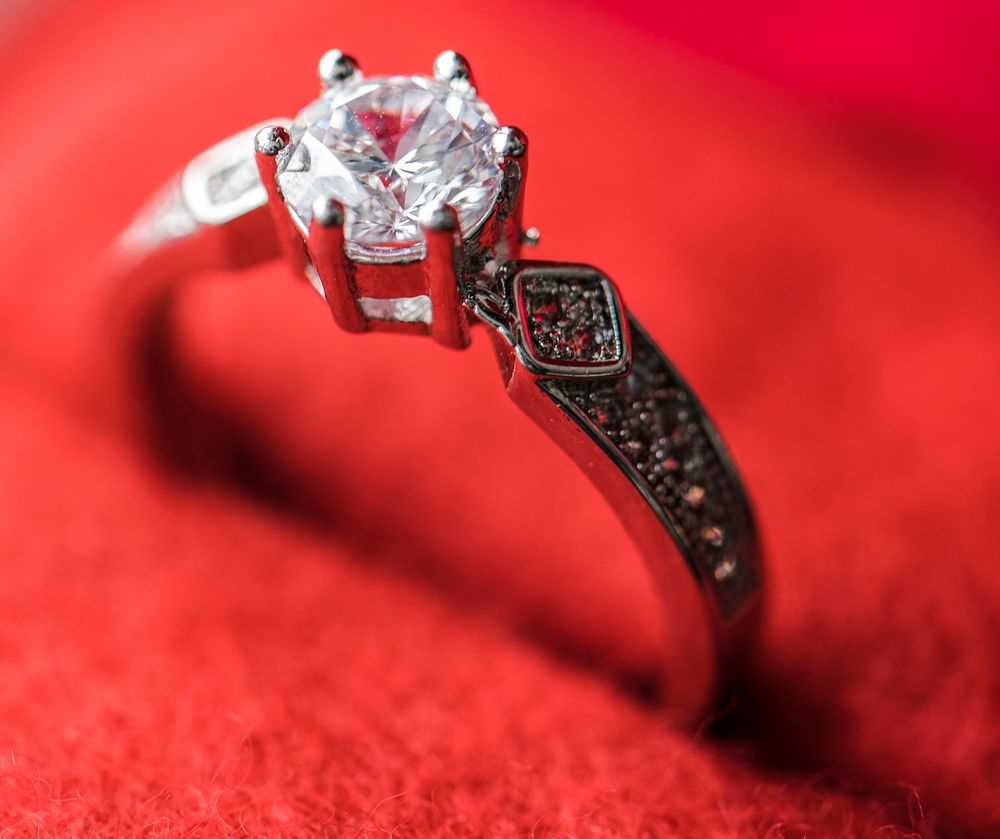 Closeup of diamond ring in red velvet box macro