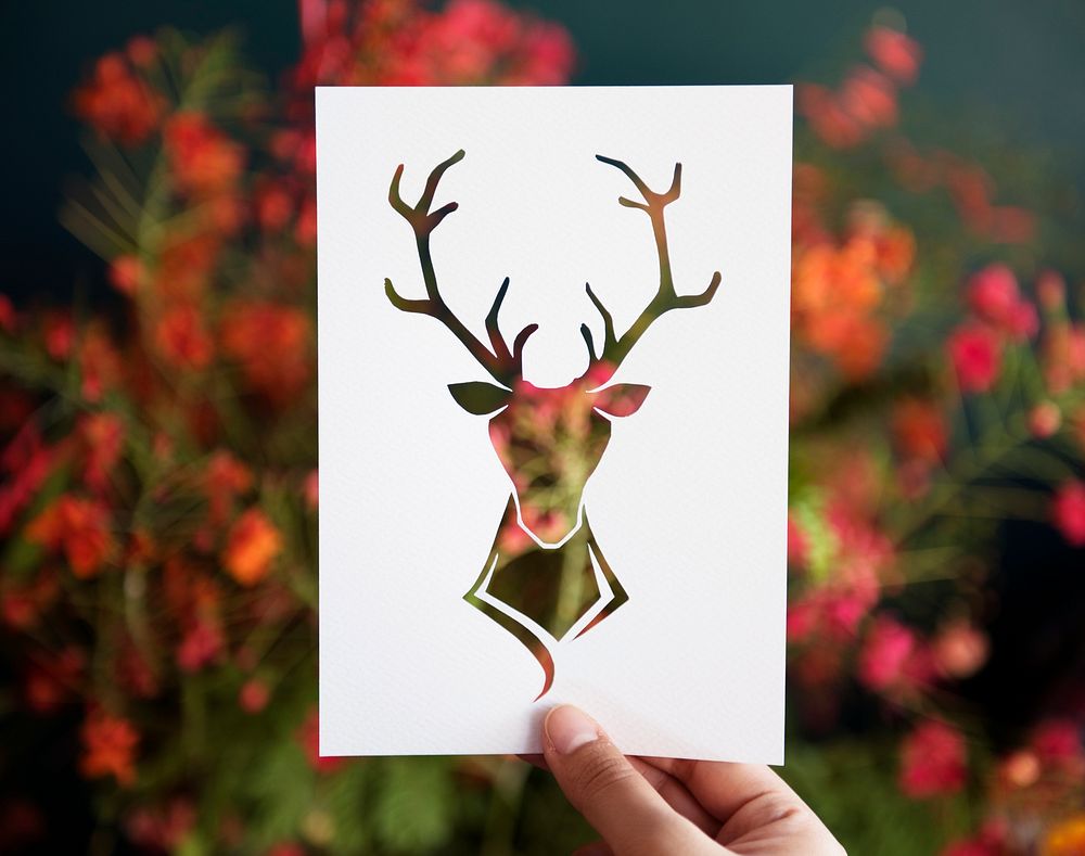 Hand Hold Deer with Antlers Paper Carving with Flower Background