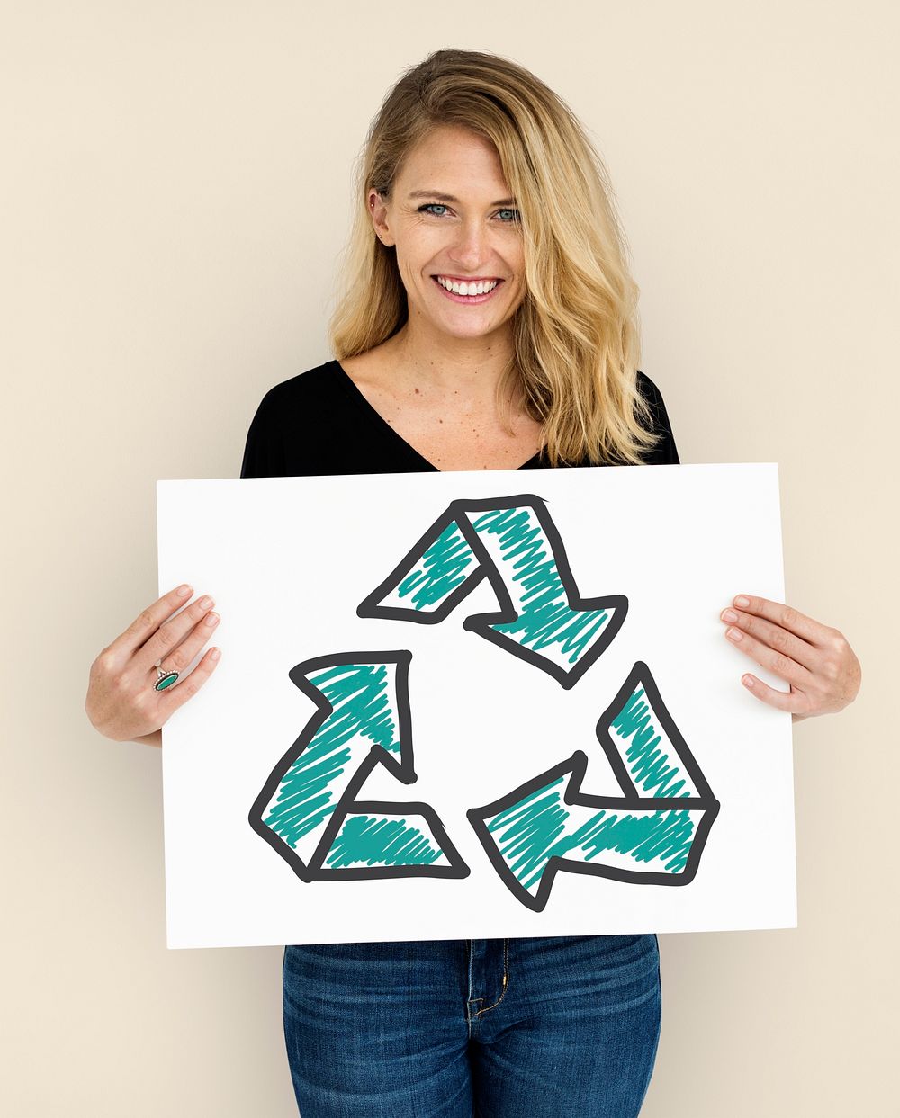 Woman holding placard with recycle sign