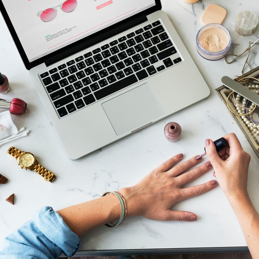 Woman applying nail polish on her fingers