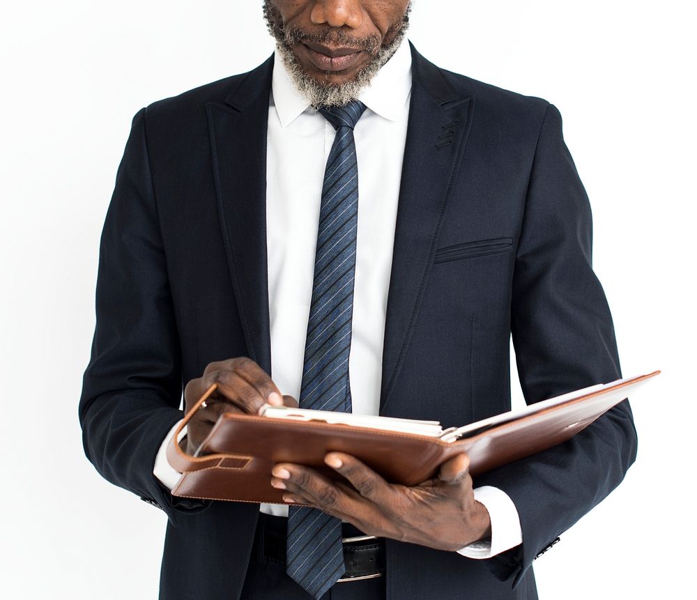 Black business man reading journal portrait