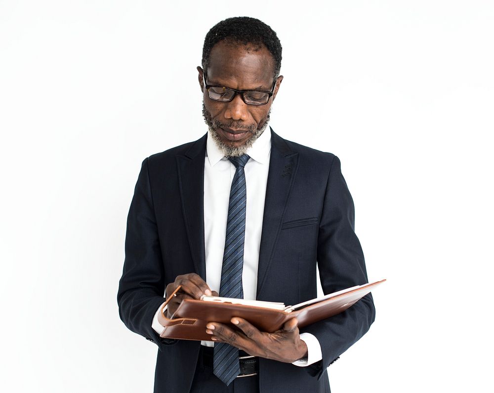 Black business man reading journal portrait