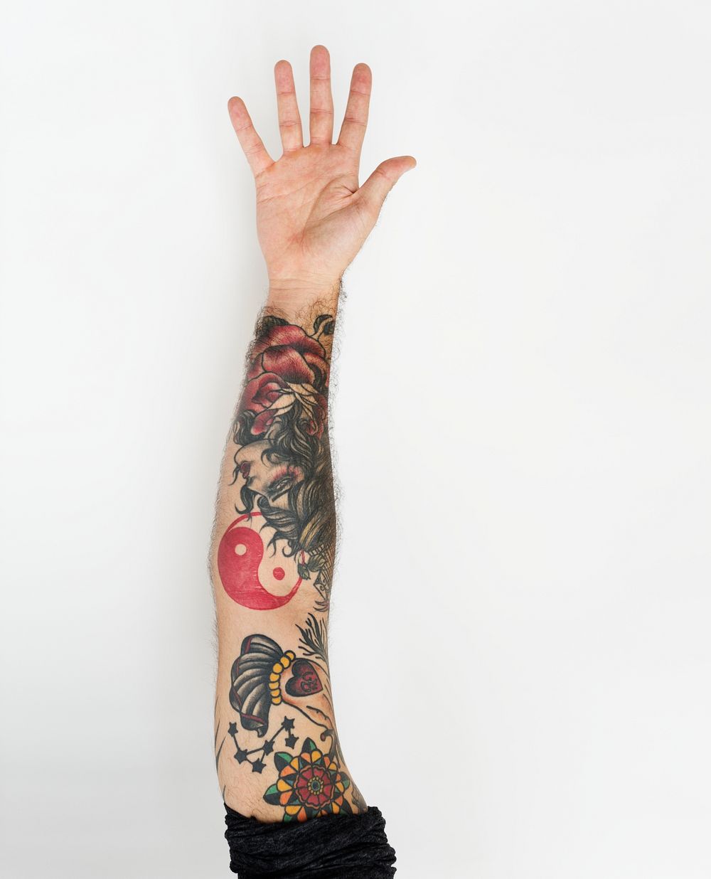 Tattooed hand of a man oustretched