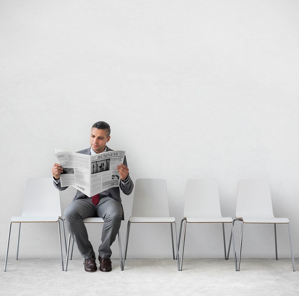 Businessman Reading Newspaper Workplace Concept