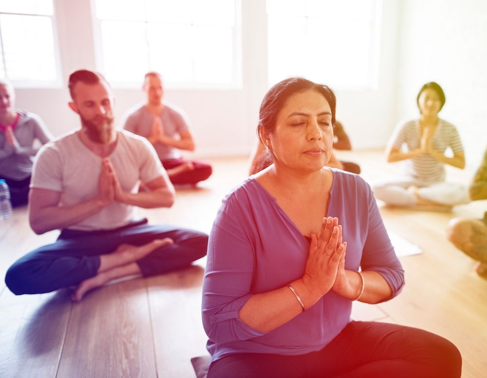 People are meditating sitting to practise