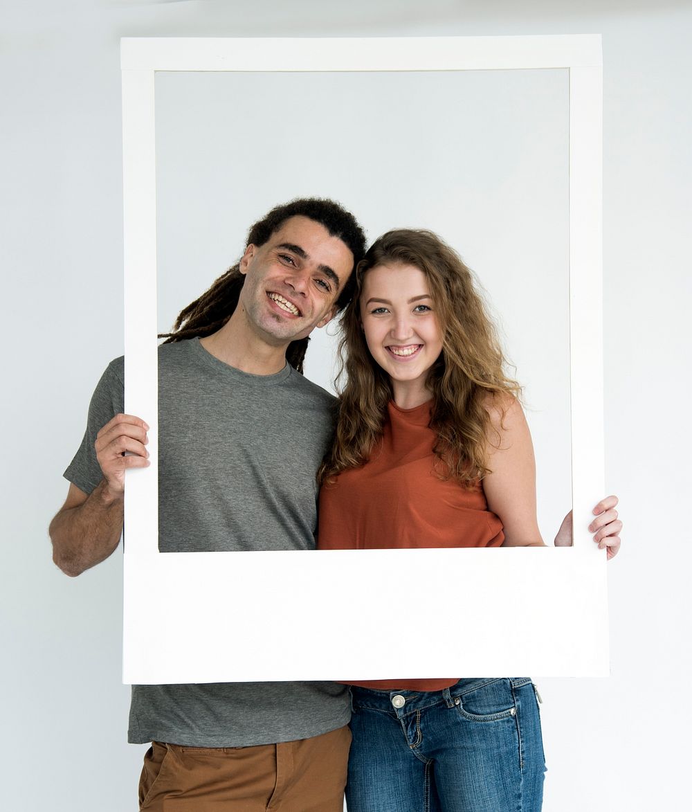 Couple holding paper frame portrait