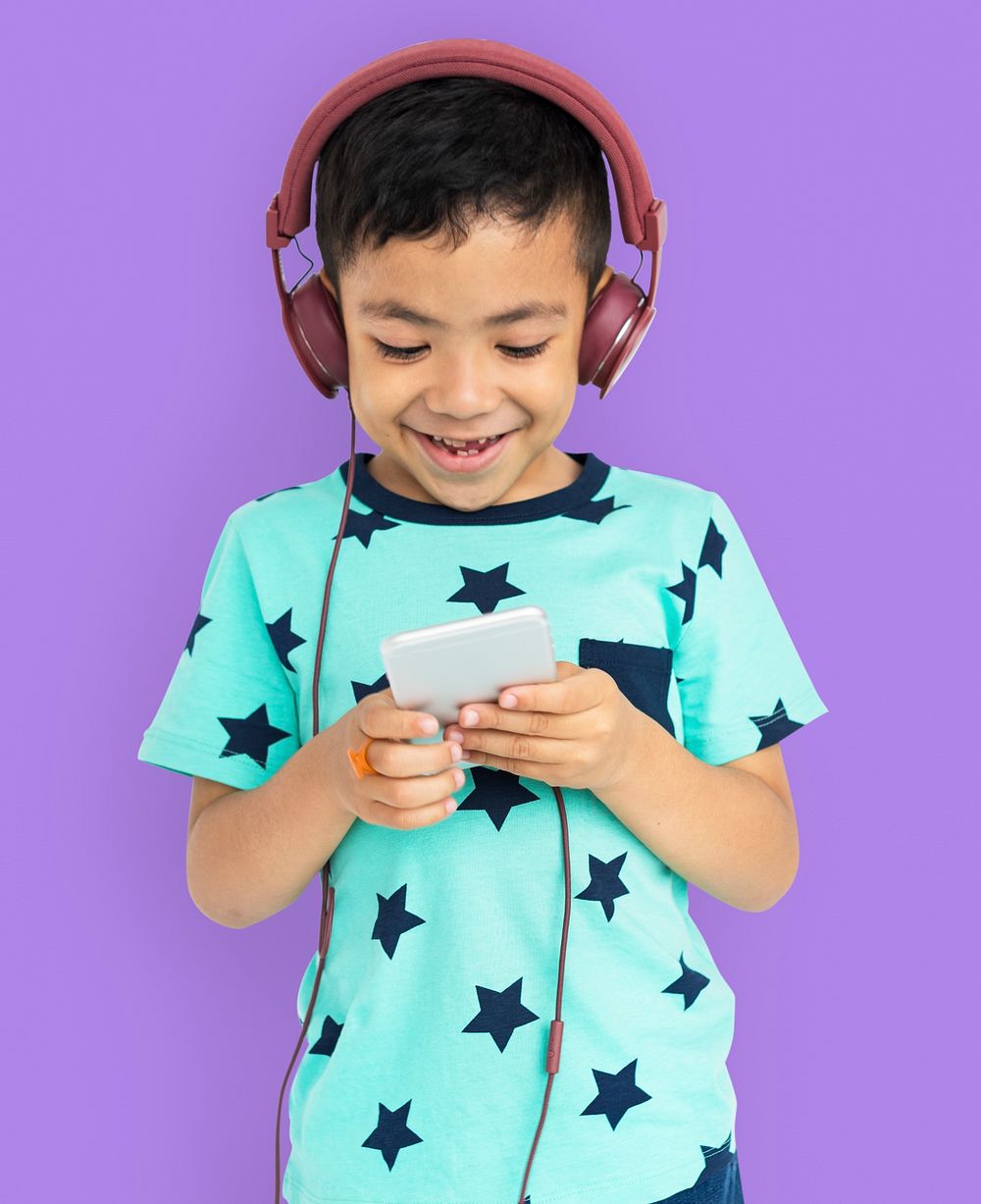 Young boy listening to music on his mobile