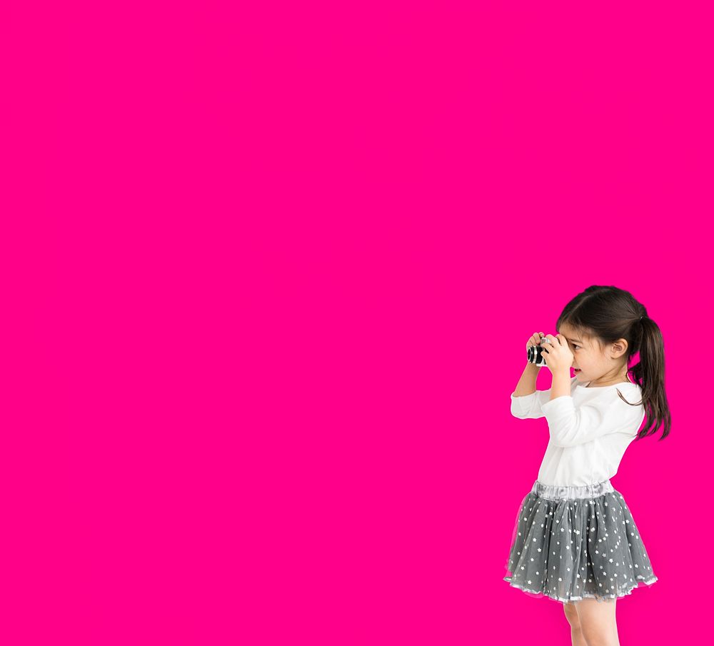 Little girl studio standing with binocular