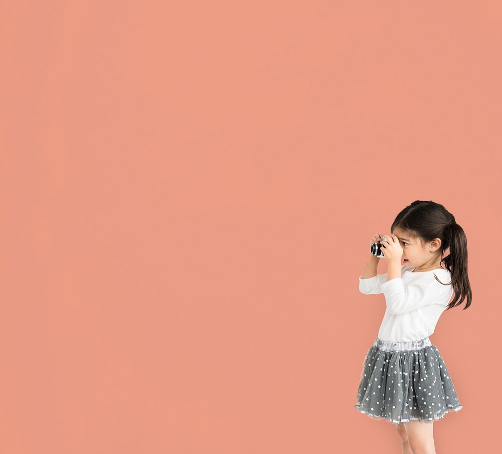 Little girl studio standing with binocular