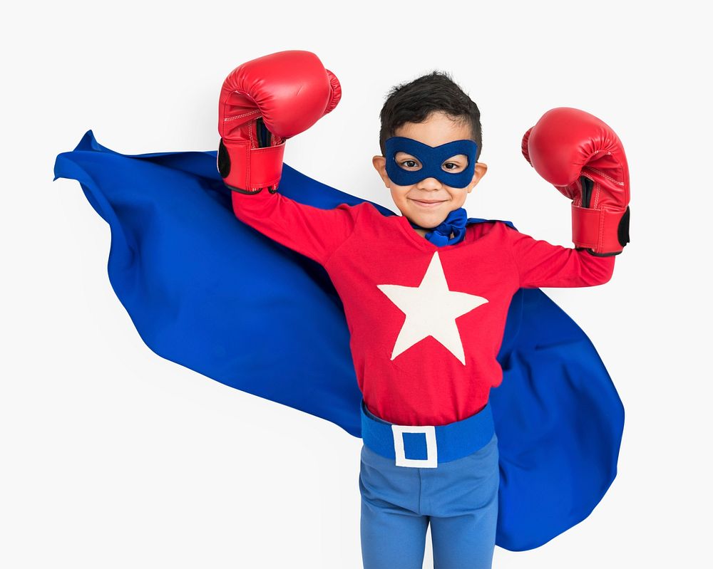 Superhero boy wearing a pear of boxing gloves
