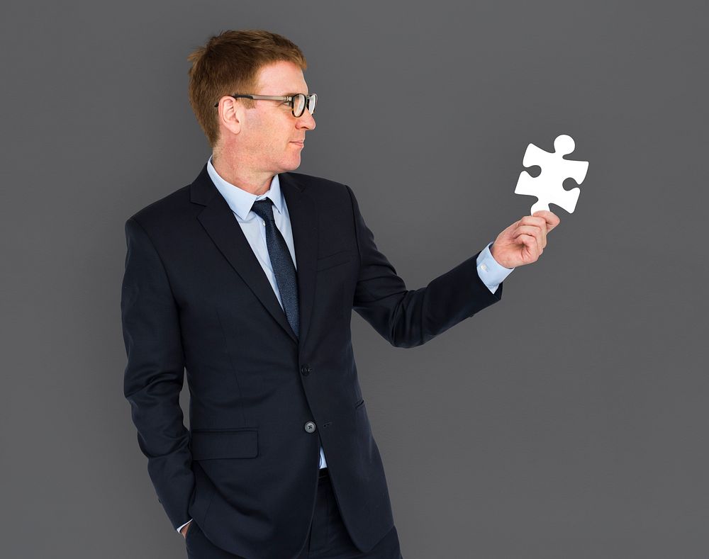Businessman holding a puzzle piece