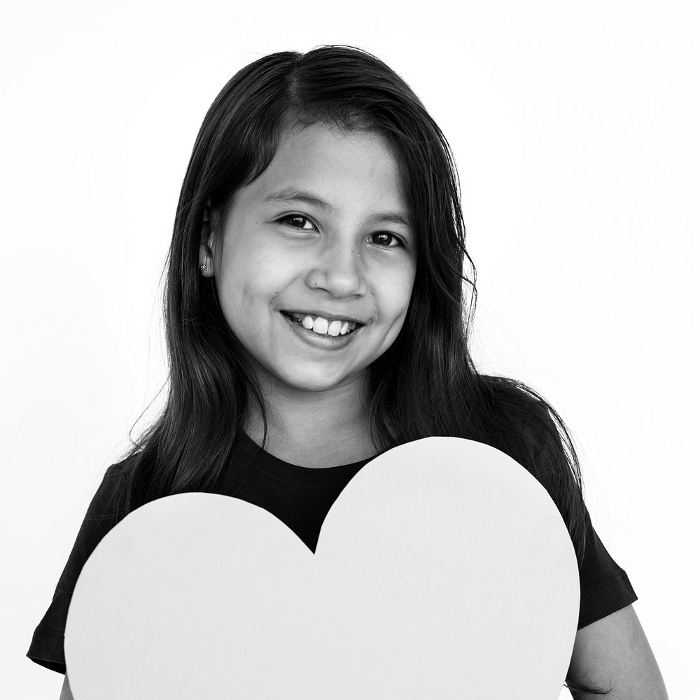 Cheerful Little Girl Hugs Heart Concept