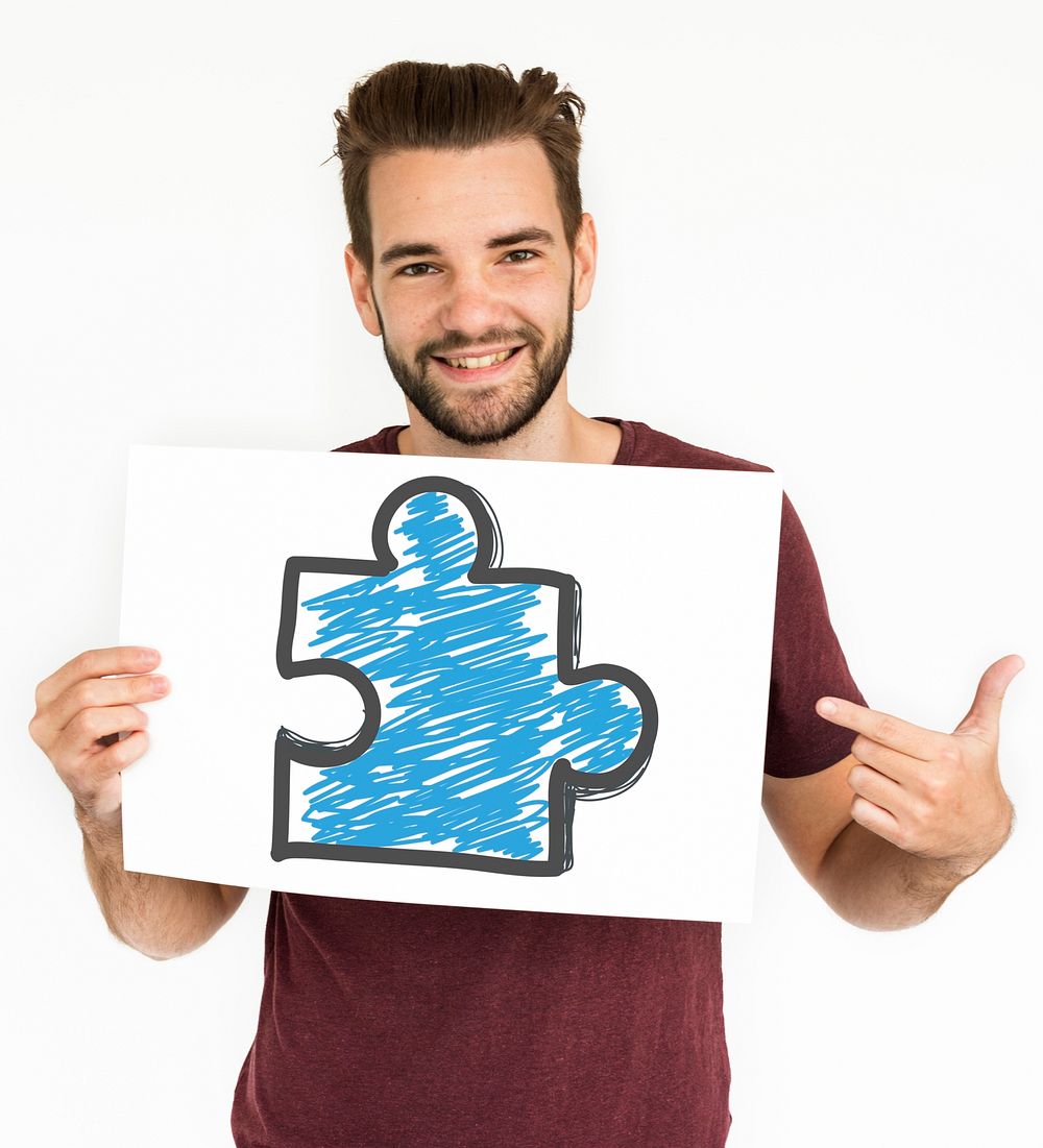 Male holding white placard with puzzle symbol