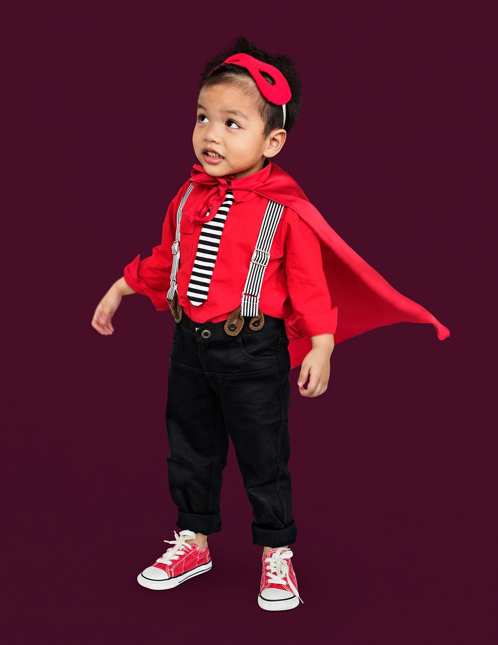 Full body portrait of a little boy in a casual superhero costume