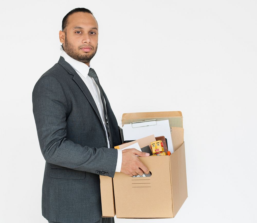 Studio portrait of a business man holding an office box