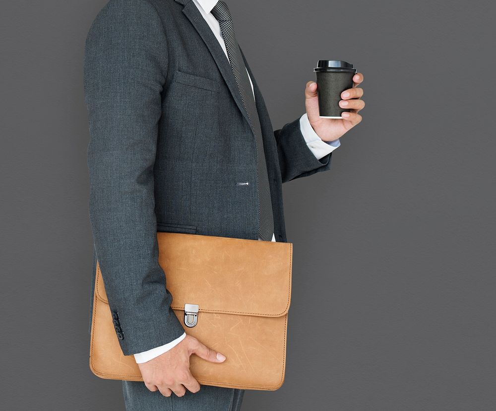Business Man Holding Coffee and Bag