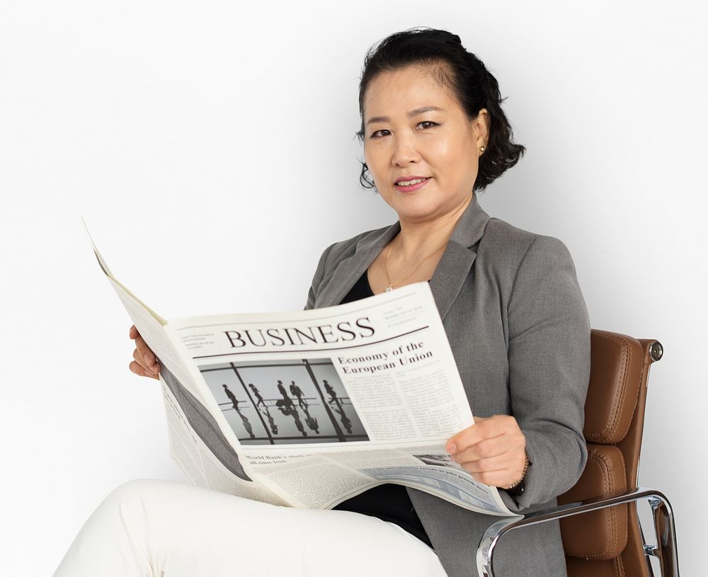 Asian Business Woman Reading Newspaper