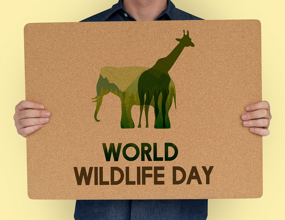 Man holding a sign with World Wildlife Day