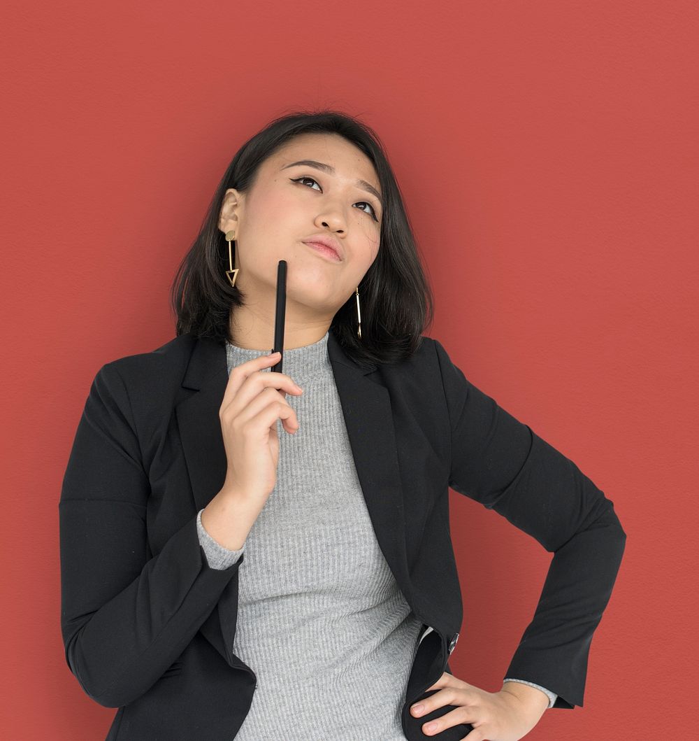 Young Asian Business Woman Thinking Pen