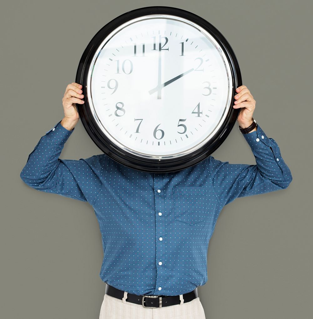 Man Holding Clock Covering Face