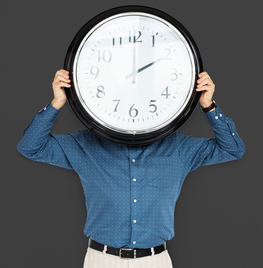 Man Holding Clock Covering Face