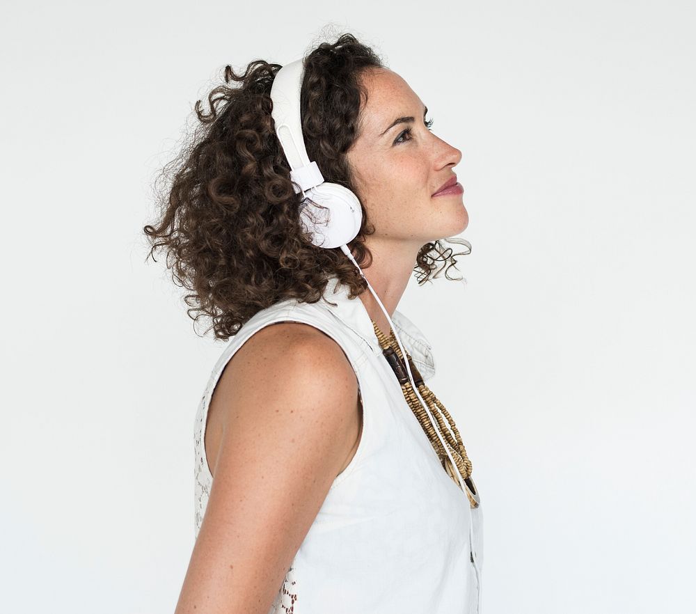 Beautiful woman listening to music in headphones