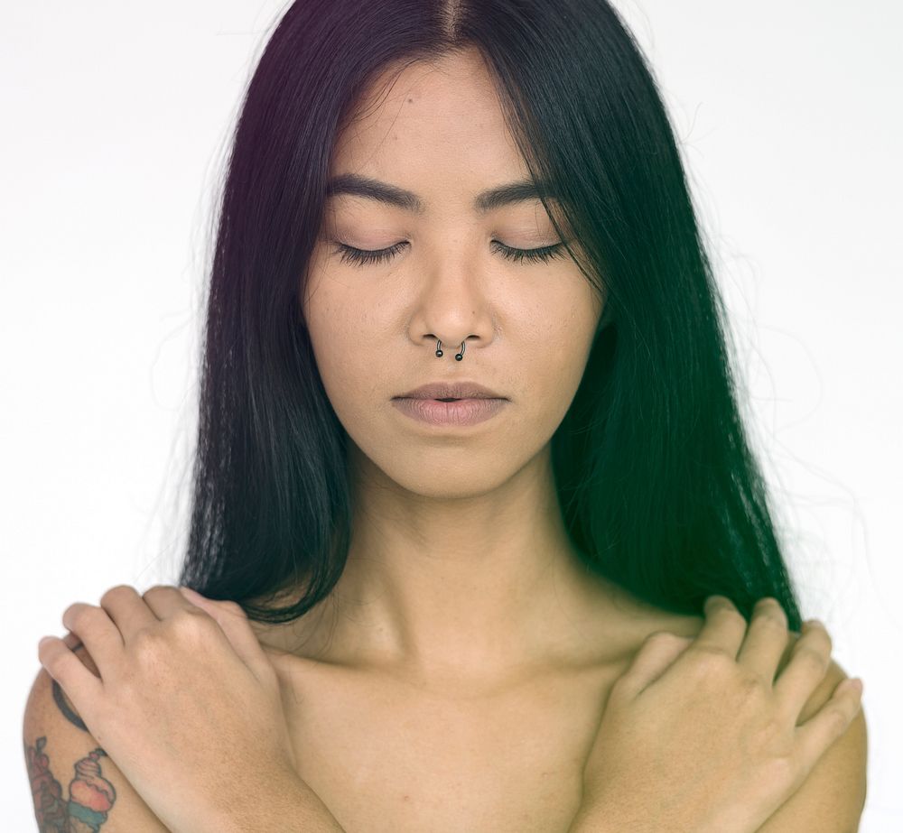 Tattoo Woman Shirtless Hugs Herself Studio Portrait