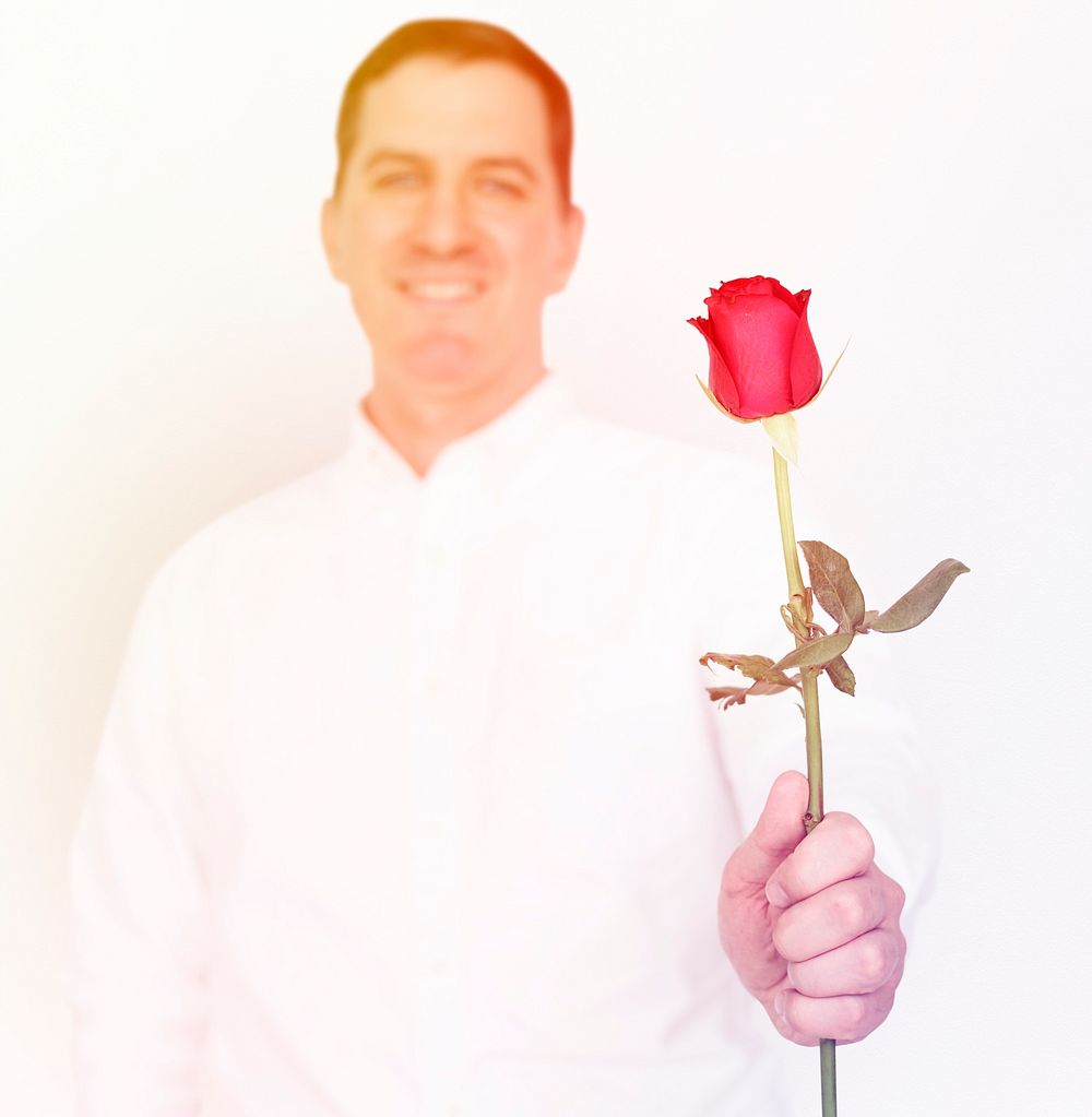 Man standing and holding rose