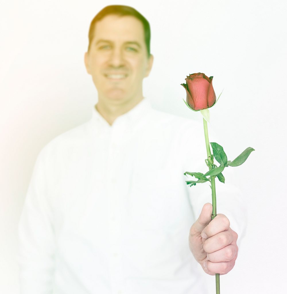 Man standing and holding rose