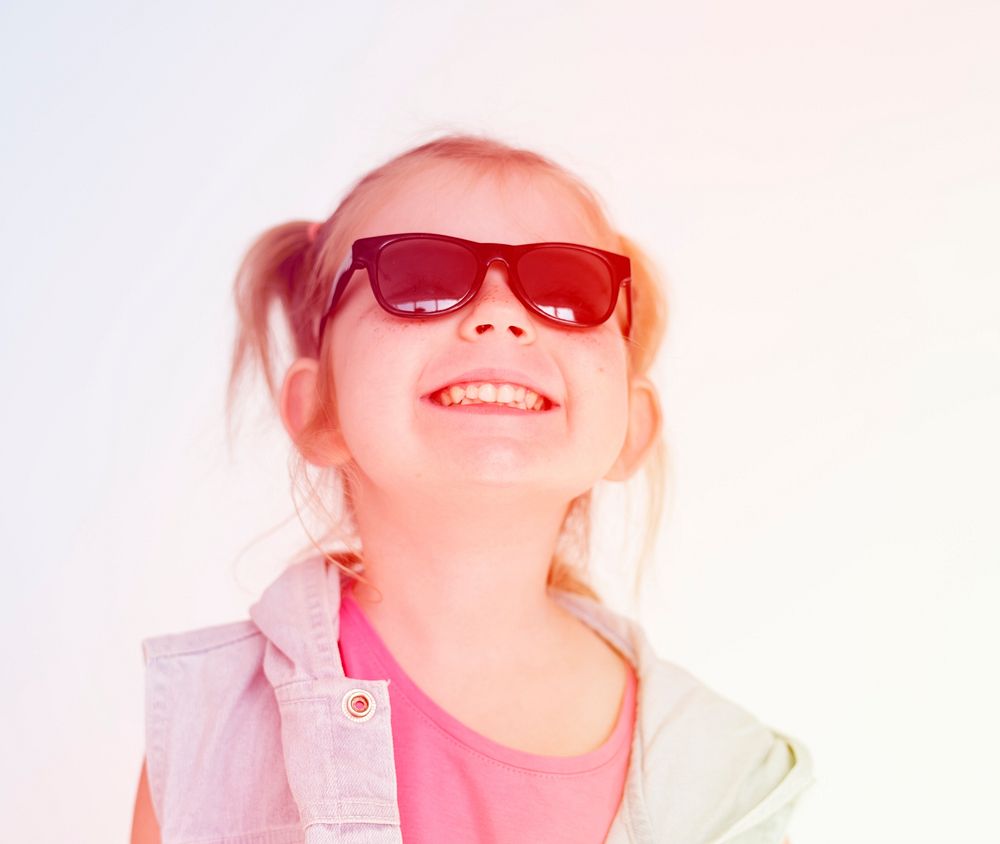 Little girl wearing sunglasses and smiling and happiness