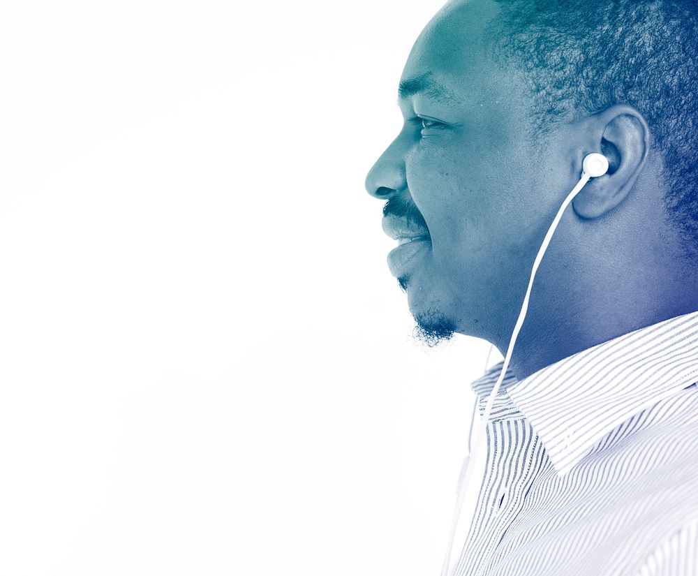 African man listening music and smiling