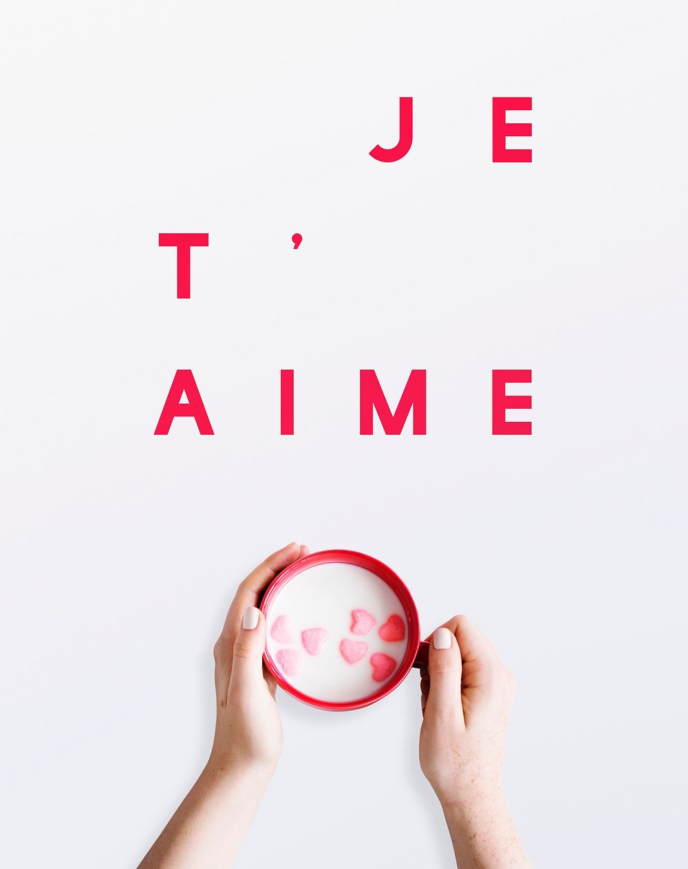 "Je T'aime" text over a woman holding a cup of heart cereal