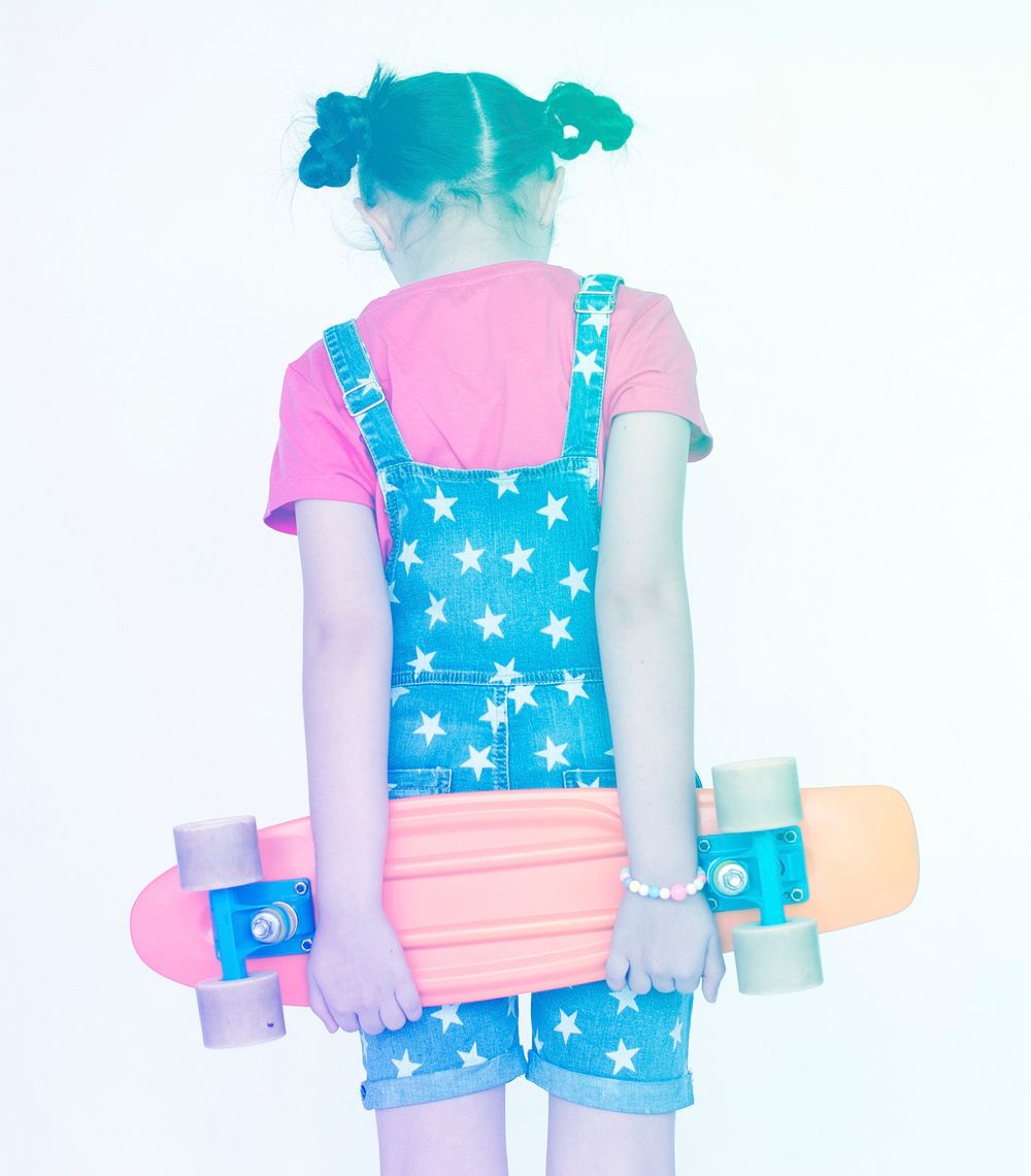 Little Girl Holding Skateboard facing other side