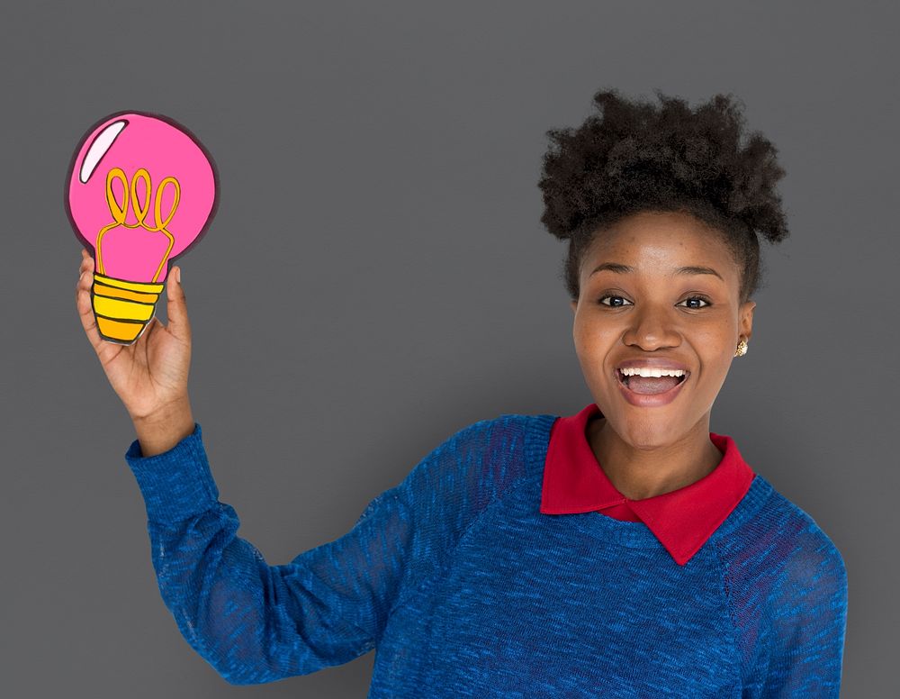 African Descent Woman Smiling and Holding Light Bulb