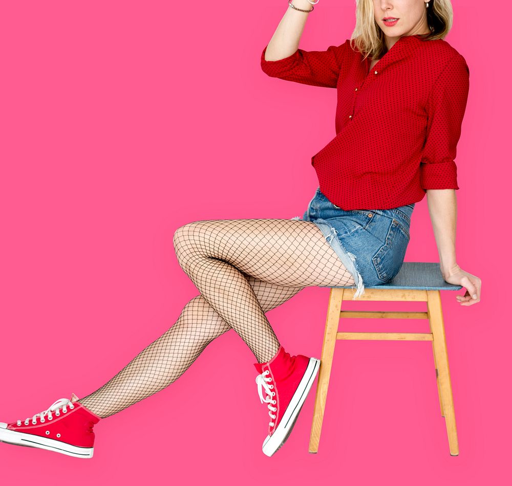 A Woman with Red Sneaker Sitting on a Chair