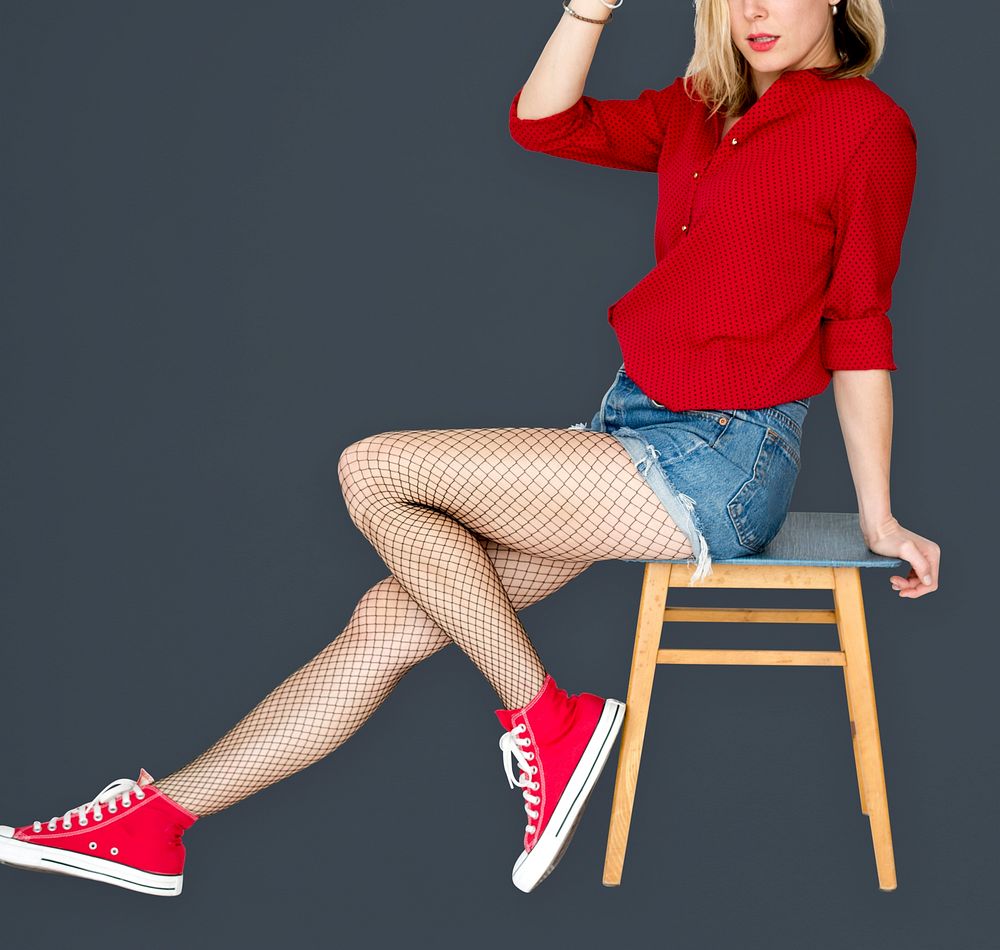 A Woman with Red Sneaker Sitting on a Chair