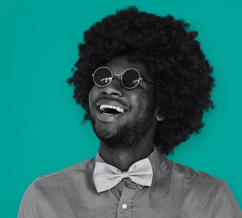 A Guy with a Black Afro Wig Smiling