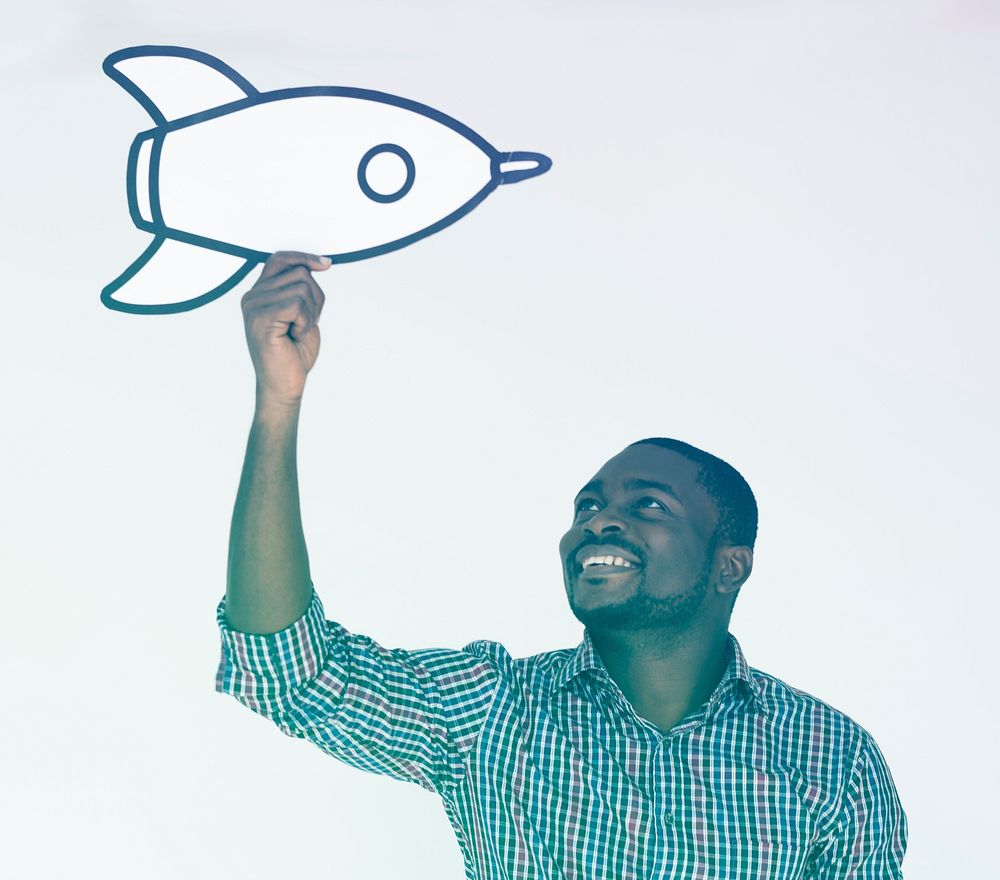 African man holding the art papercraft rocket on white background