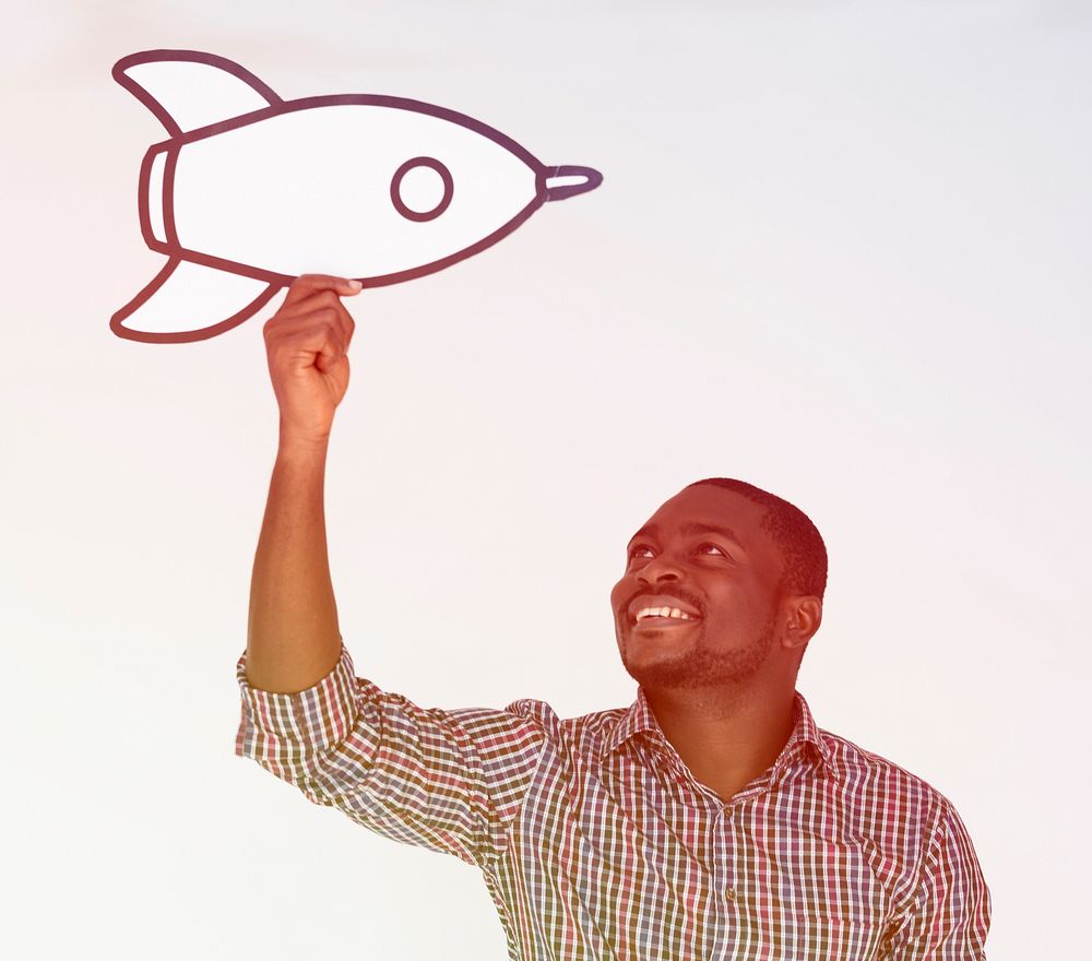 African man holding the art papercraft rocket on white background