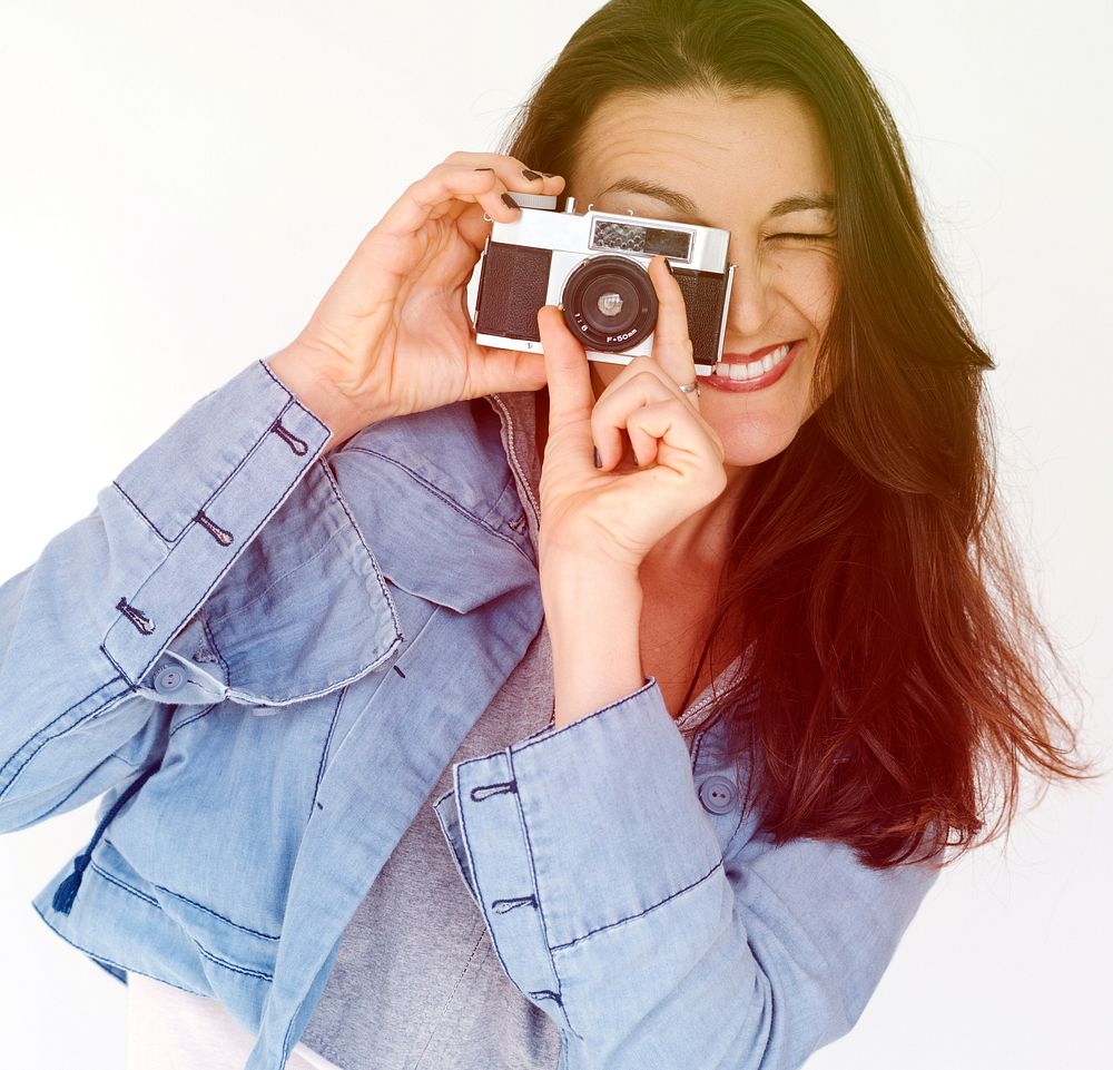 Woman photographer holding camera and focusing