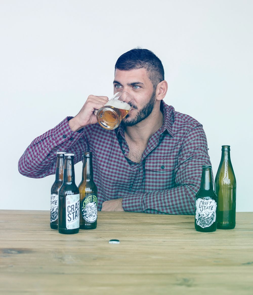 Middle eastern drinking beer on the wooden table