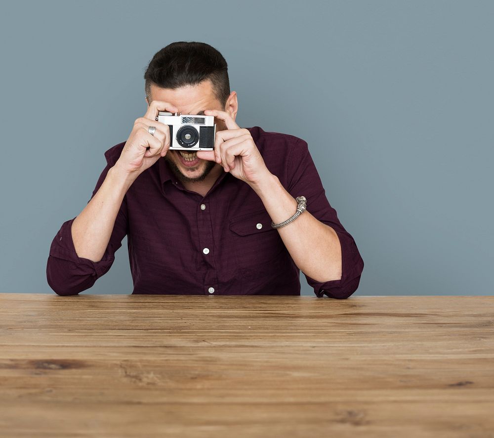 A man taking a photo by film camera